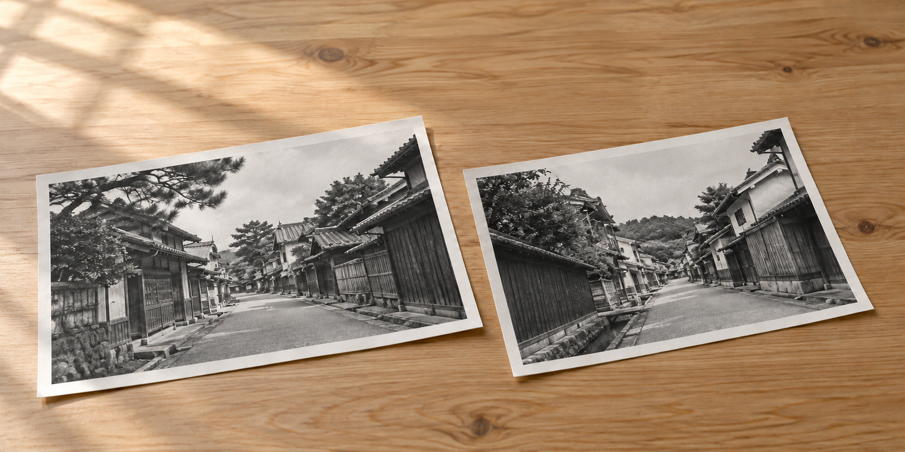 町並みの白黒写真を二枚並べた机上の資料